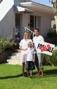 happy-family-in-front-of-their-new-house